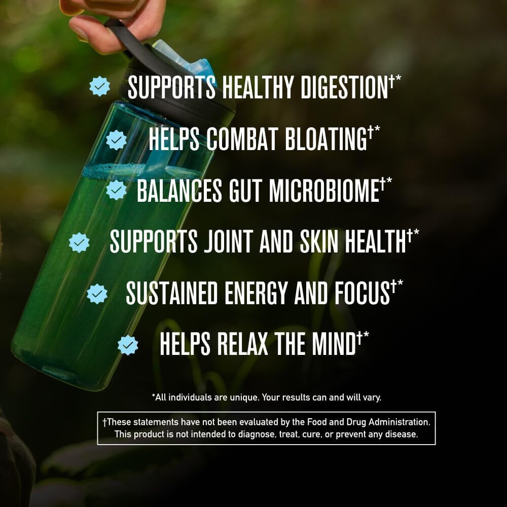 Green bottle held by a hand with health benefits listed on a blurred natural background